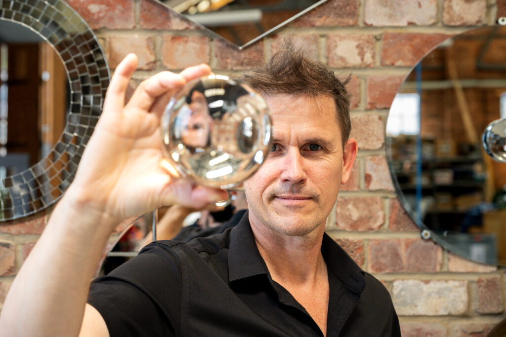 Image of artist Luke Jerram with a glass ball